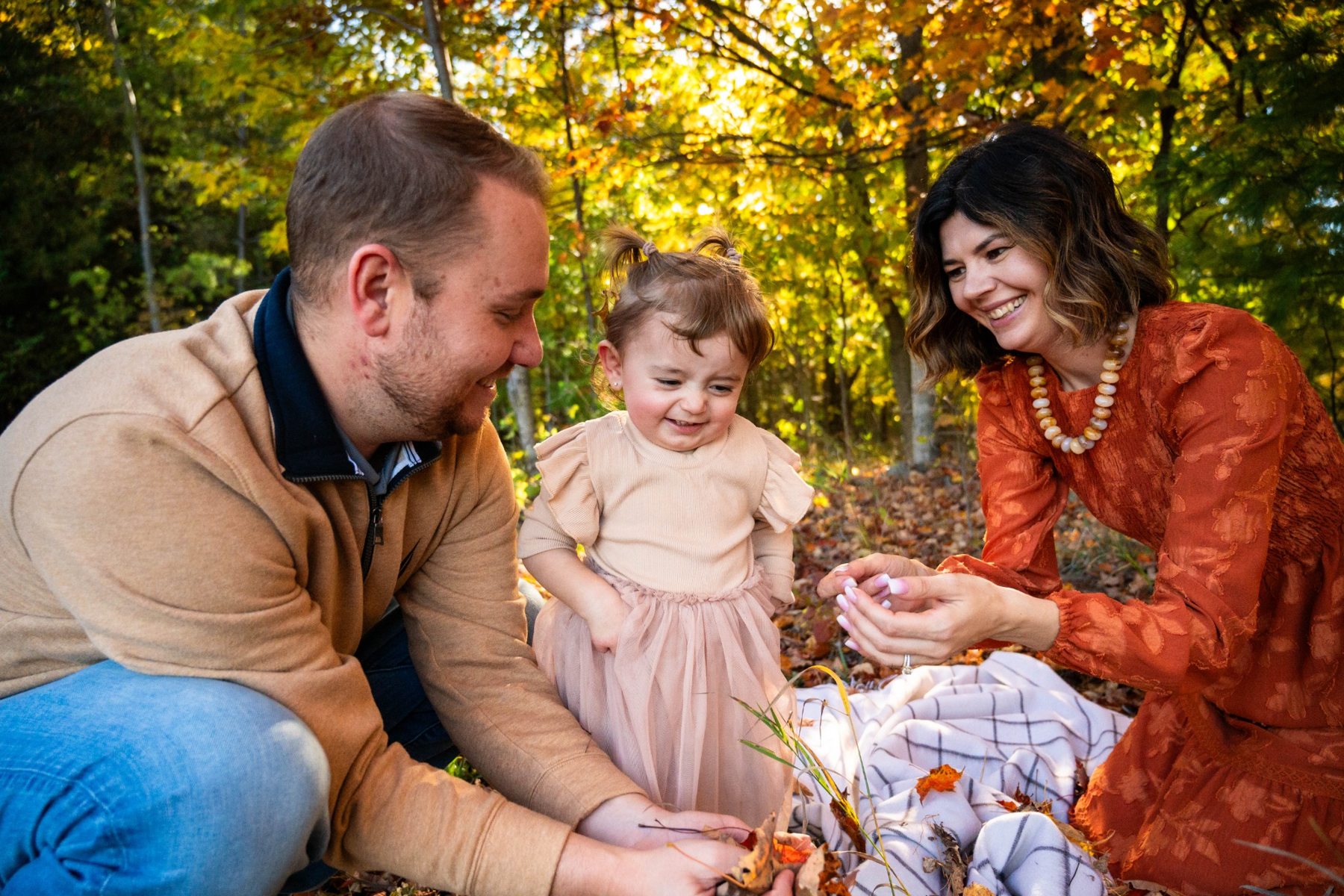 A family sharing a candid moment in autumn
